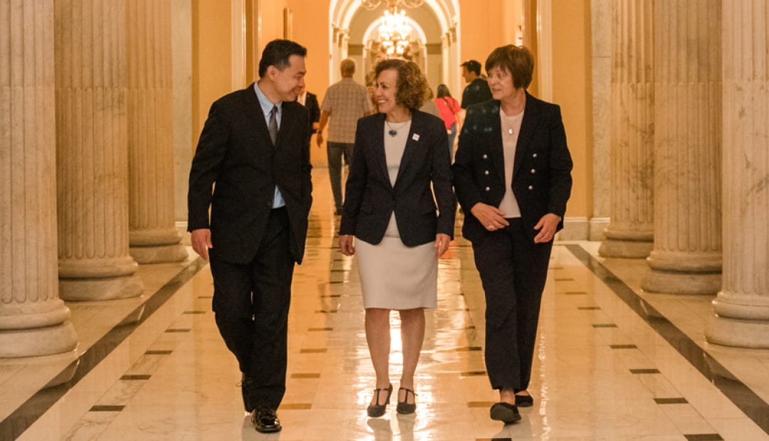 Tony Yang, Pam Jeffries and Jean Johnson walk the hall of the Capitol