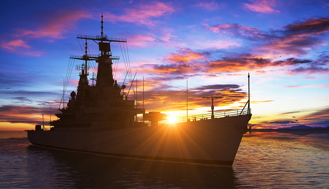 Navy ship at sunset