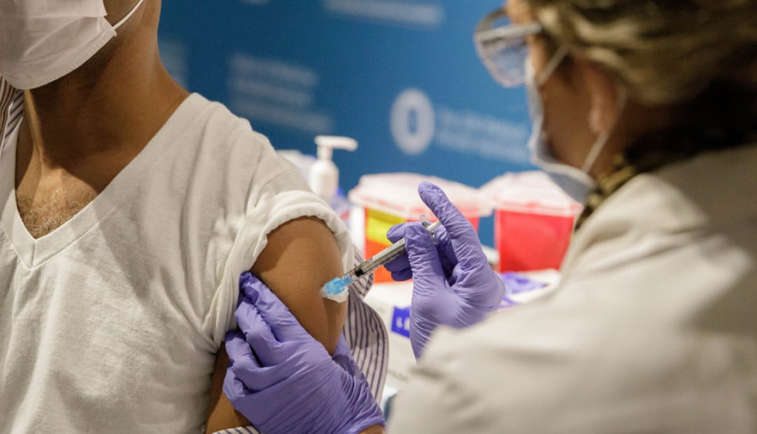 Nurse giving vaccine to patient